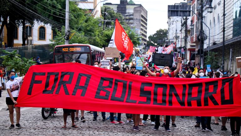 &#39;Bolsonaro out&#39;, one banner read, while others accused him of genocide. Pic: AP