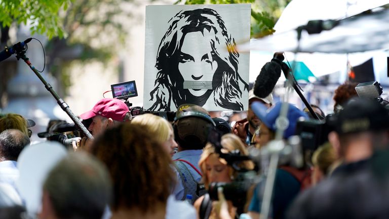 A portrait of Britney Spears looms over supporters and media members outside a court hearing concerning the pop singer&#39;s conservatorship in Los Angeles. Pic: AP


