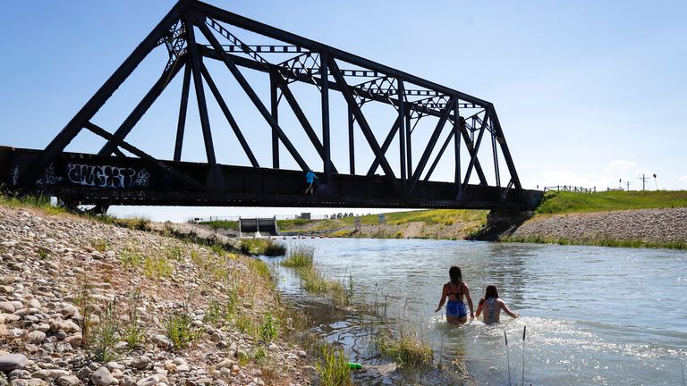 People cool down in a canal in Alta, Canada. Pic: AP