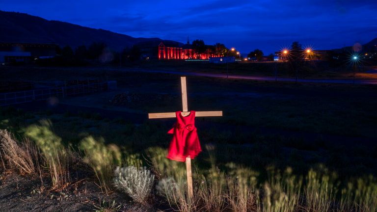 A cross outside the former school where the remains of 215 children were found in Saskatchewan (Pic: AP) 