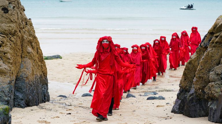 Climate protesters march along Carbis Bay near St Ives