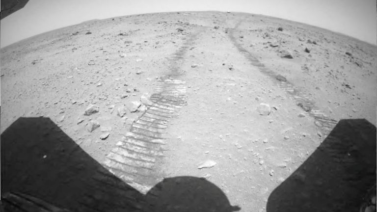 Ruts on the surface of Mars are seen from the rear of the Chinese rover Zhurong