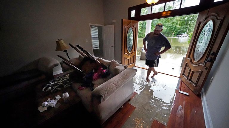 Danny Gonzales, walks in his flooded house as water recedes, after Tropical Storm Claudette passed through, in Slidell, La., Saturday, June 19, 2021. The National Hurricane Center declared Claudette organized enough to qualify as a named storm early Saturday, well after the storm&#39;s center of circulation had come ashore southwest of New Orleans.(AP Photo/Gerald Herbert)