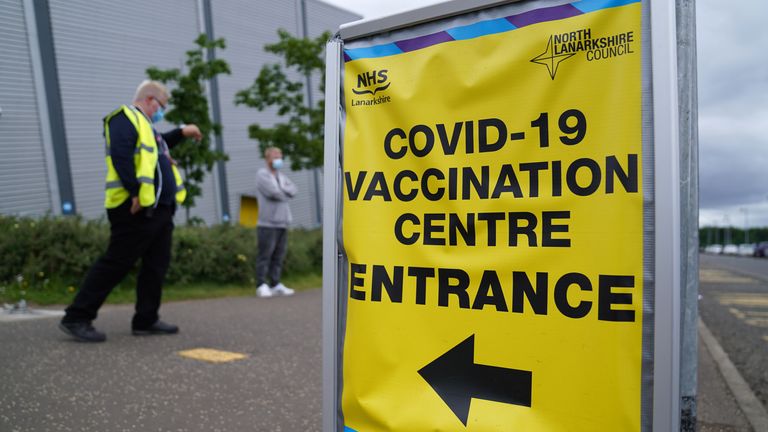 People queue outside a vaccinations centre in Motherwell