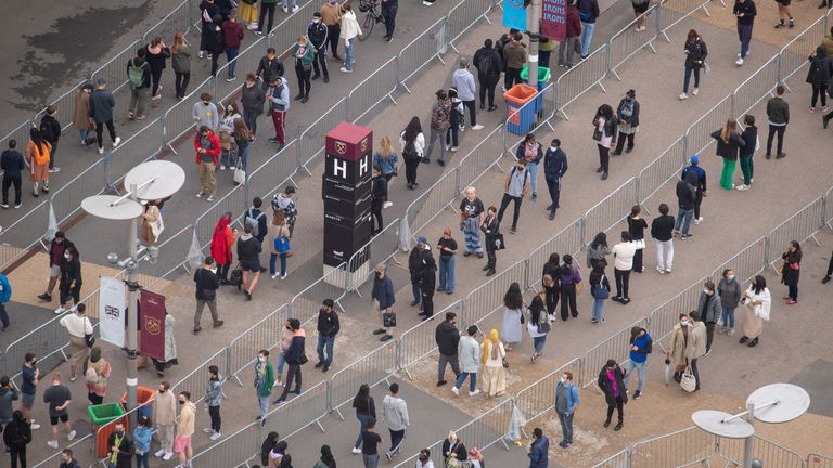 People queue outside an NHS Vaccination Clinic at West Ham&#39;s London Stadium in Stratford, east London. The NHS is braced for high demand as anyone in England over the age of 18 can now book a Covid-19 vaccination jab. Picture date: Saturday June 19, 2021.