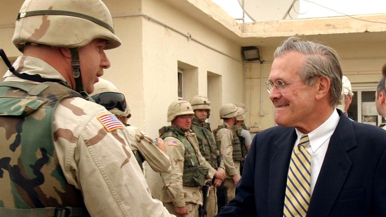U.S. Secretary of Defence Donald Rumsfeld greets U.S. military personnel during a visit to the Abu Ghraib prison on the outskirts of Baghdad in 2004