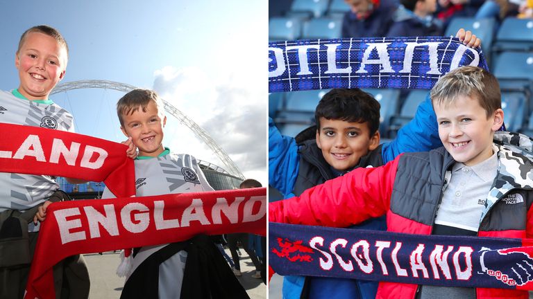 Young England fans pose with a scarf outside the stadium prior to the Euro 2020 Qualifying Group A match at Wembley Stadium, London.