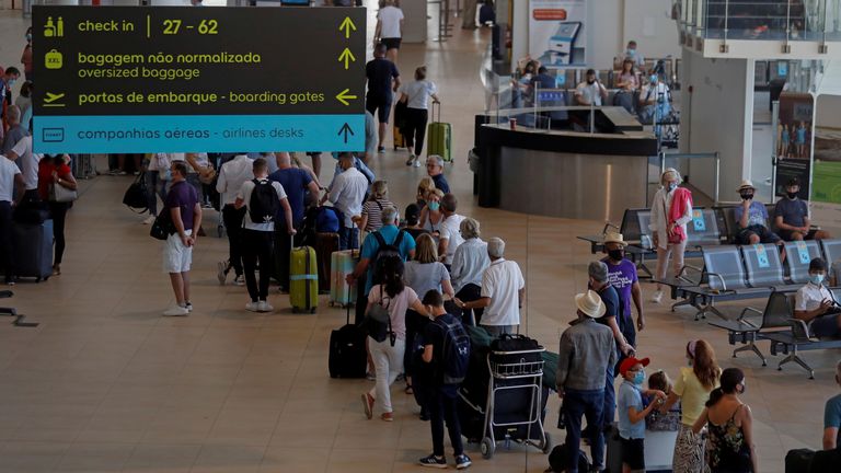 People wait in queues at Faro airport amid the coronavirus disease (COVID-19) pandemic, in Faro, Portugal, June 6, 2021. REUTERS/Pedro Nunes