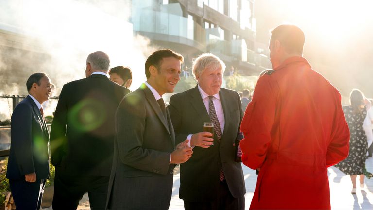 12/06/2021. Carbis Bay, United Kingdom. Prime Minister Boris Johnson G7 Leaders Summit Day Two. The Prime Minister Boris Johnson with the The President of France Emmanuel Macron talking to a Red Arrows pilot at the G7 Summit in Carbis Bay, Cornwall. Pic:  Andrew Parsons / No 10 Downing Street


