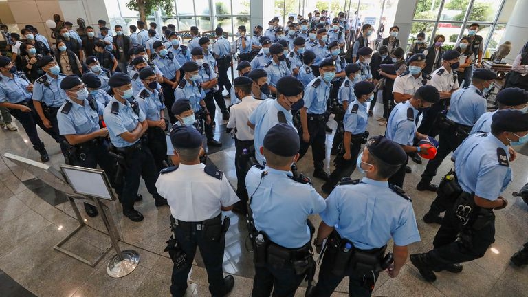 Police officers gather at lobby of  Apple Daily headquarters. Pic: AP