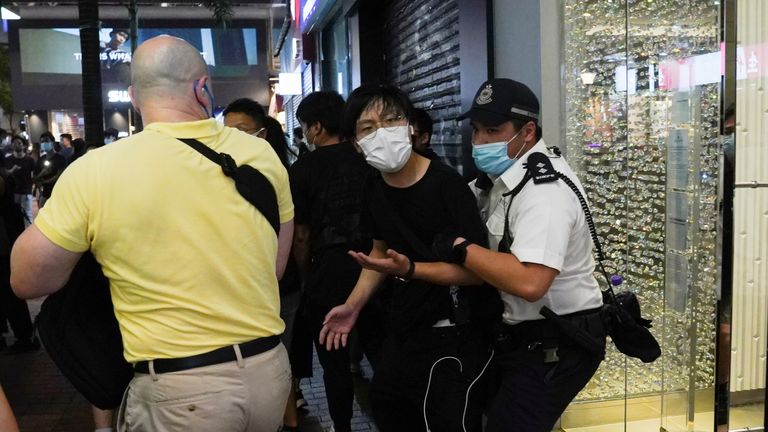 A police officer detains a man at Causeway Bay on the 32nd anniversary of the crackdown on pro-democracy demonstrators at Beijing&#39;s Tiananmen Square in 1989, in Hong Kong, China June 4, 2021. REUTERS/Lam Yik
