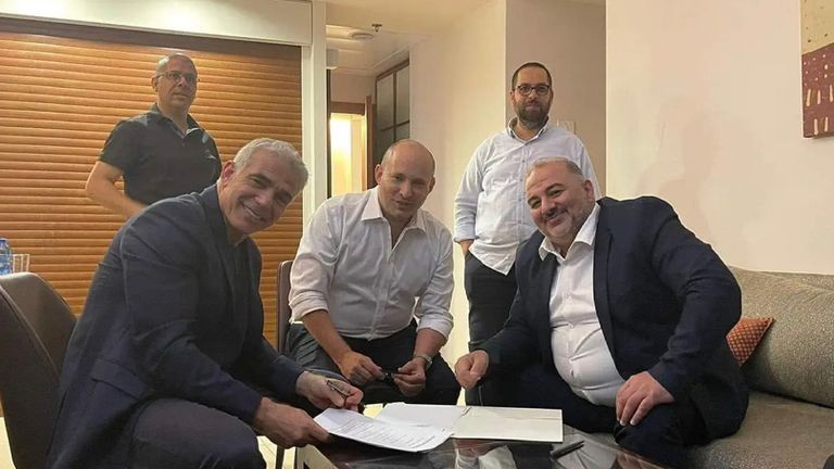 The deal being signed, with Yair Lapid,  a secular centrist on the left. In the middle is Naftali Bennett, a hard line nationalist, and on the right, Mansour Abbas, an Islamist Arab. Pic: Nawaf Alnabary, Kan news