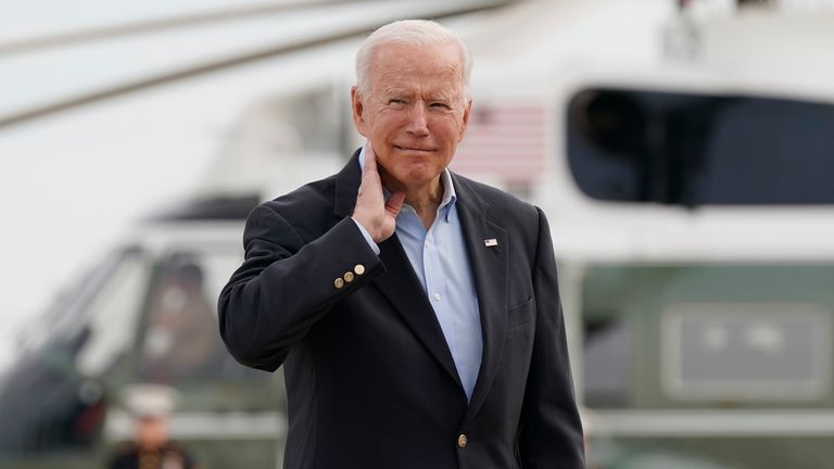 President Joe Biden pantomimes how he earlier had to brush a cicada off his neck as he and first lady Jill Biden prepare to board Air Force One, Wednesday, June 9, 2021, at Andrews Air Force Base, Md. Biden is embarking on the first overseas trip of his term, and is eager to reassert the United States on the world stage, steadying European allies deeply shaken by his predecessor and pushing democracy as the only bulwark to the rising forces of authoritarianism. (AP Photo/Patrick Semansky)
