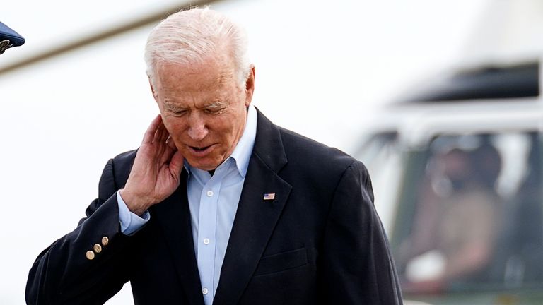 Joe Biden knocks off a cicada before stepping onto Air Force One for the G7 summit in Cornwall