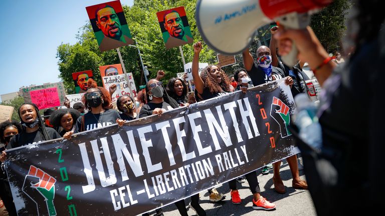 Protesters marching after a Juneteenth rally in Brooklyn, New York, in June last year                                                                                            