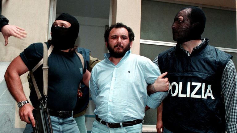 Anti-Mafia police wearing masks to hide their identity, escort top Mafia fugitive Giovani Brusca