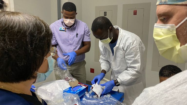 Health workers are seen preparing blood supplies as the hunt goes on for survivors