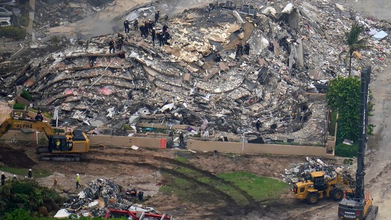 These aerial images show search and rescue workers working the site of an oceanfront condo building that partially collapsed, with at least one dead and over 100 persons unaccounted for, in Surfside, Fla., Friday, June 25, 2021. (AP Photo/Gerald Herbert)