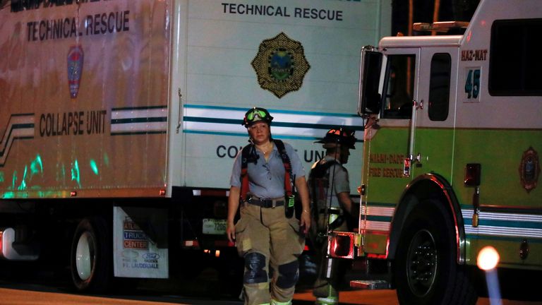 Emergency personnel work at the scene of a partial building collapse in Miami