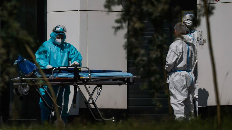 A medical specialist pushes a stretcher outside a hospital in Moscow
