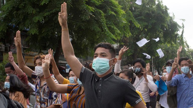 Anti-coup protestors flash the three-finger salute during a flash mob protest in Yangon, Myanmar