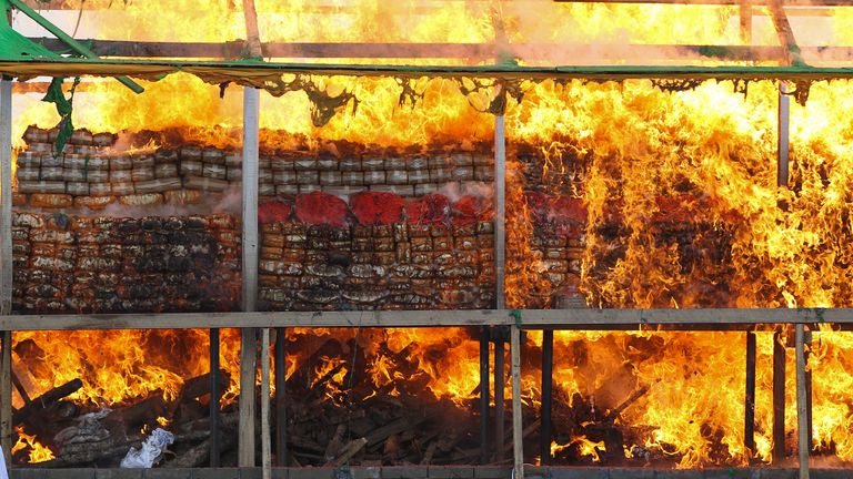 Smokes and flames billow from burning of illegal narcotics during a destruction ceremony on the outskirts of Yangon, Myanmar, Saturday, June 26, 2021. Myanmar burned over US$ 680 million worth of assorted drugs seized around the country on Saturday to commemorate the International Day against Drug Abuse and Illicit Trafficking. (AP Photo/Thein Zaw)