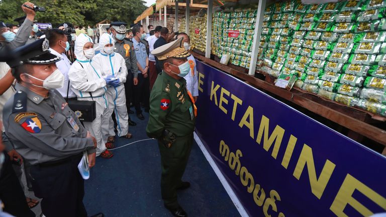 Home Affair Minister, Lieutenant General Soe Htut, center, inspects seized illegal drugs before being burnt during a destruction ceremony on the outskirts of Yangon, Myanmar, Saturday, June 26, 2021. Myanmar burned over US$ 680 million worth of assorted drugs seized around the country on Saturday to commemorate the International Day against Drug Abuse and Illicit Trafficking. (AP Photo/Thein Zaw)