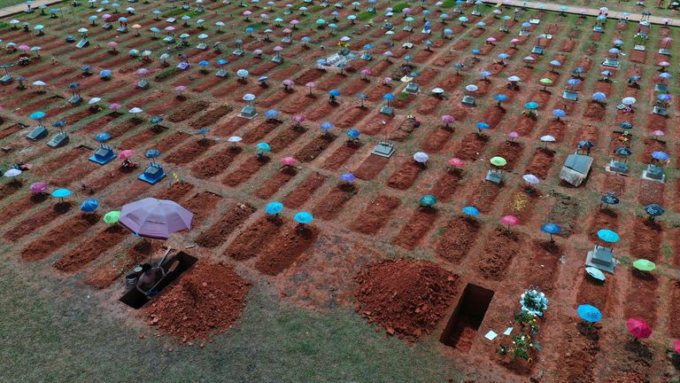 A worker digs a grave in the San Juan Bautista cemetery in Iquitos, Peru. Pic: AP