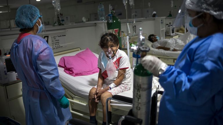 A COVID-19 patient breathes oxygen and monitored by doctors at the Regional Hospital in Iquitos, Peru. Pic: AP