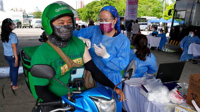 A food delivery driver gets a drive-thru vaccine in Manilla on Tuesday. Pic: AP