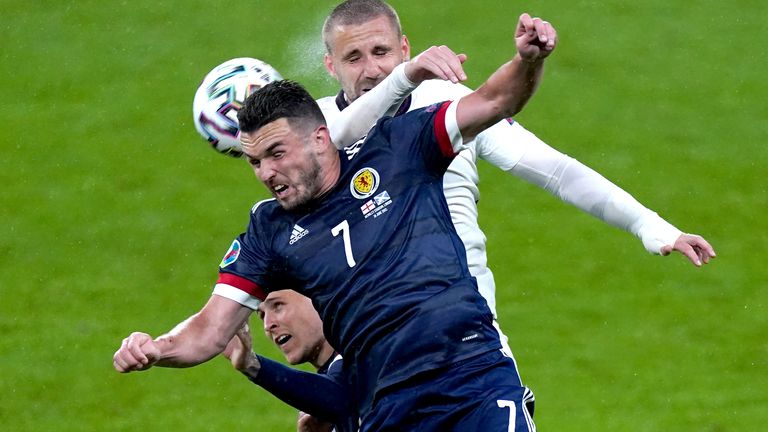 Scotland&#39;s John McGinn (front) and England&#39;s Luke Shaw battle for the ball during the UEFA Euro 2020 Group D match at Wembley Stadium, London. Picture date: Friday June 18, 2021.