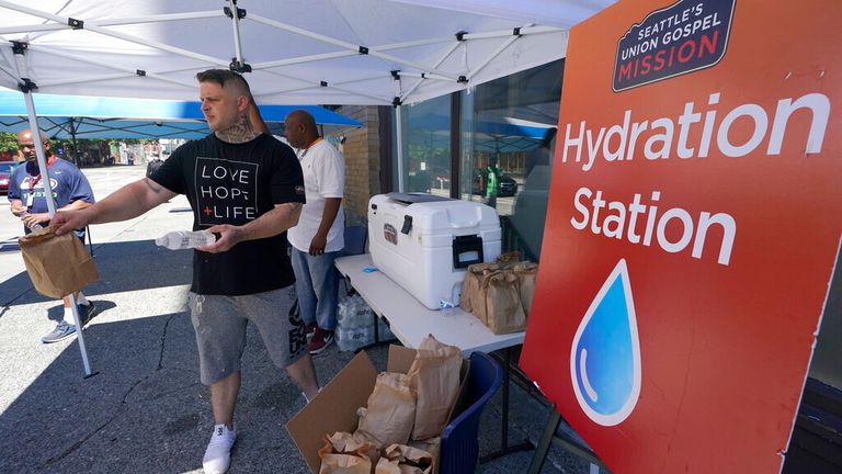 A local Christian group gives out water in Seattle on Monday. Pic: AP