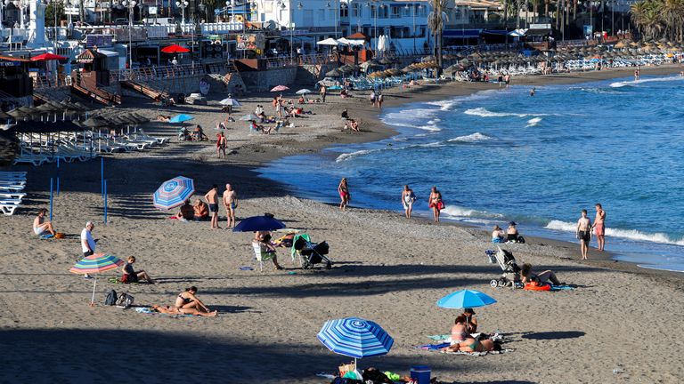 People cool off on a beach in Benalmadena, southern Spain