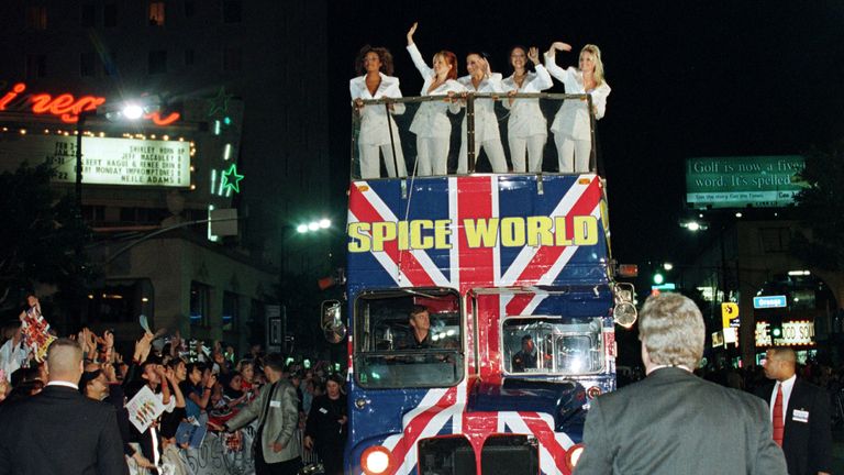 The Spice Girls wave from the top of a bus on Hollywood Boulevard for the premiere of Spice World the film in January 1998
