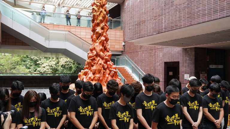 Students observed a minute&#39;s silence in front of the Pillar of Shame statue at Hong Kong University on Friday