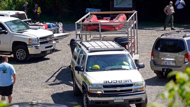 Rescue workers are seen near the Dan River on Friday 