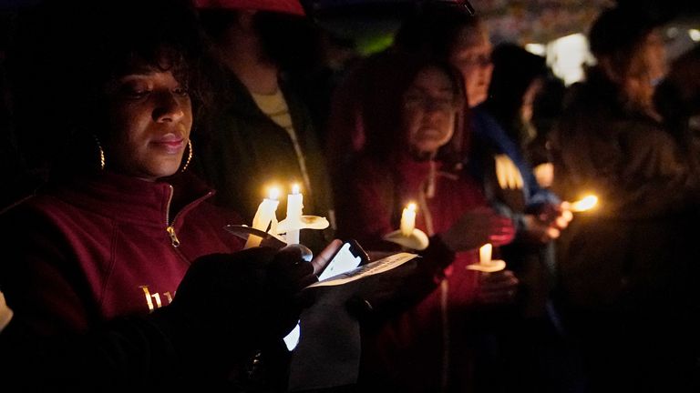 People hold candles at a candlelight vigil in honour of the victims of the Tulsa race massacre. Pic AP 