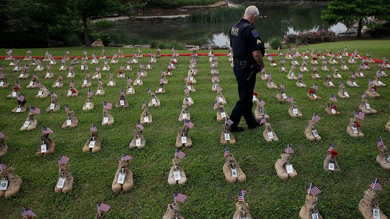 Police Sargeant Joel Ward views the Field of Heroes at Centennial Park. The field contains empty boots to give a visual representation of Oklahoma&#39;s fallen service members. Pic AP