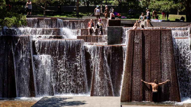 People cool off in a public fountain during an unprecedented heat wave in Portland, Oregon, U.S. June 27, 2021. REUTERS/Maranie Staab