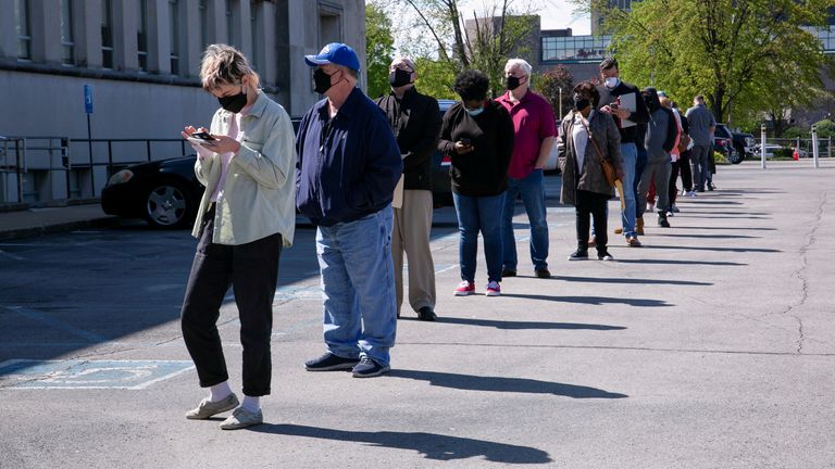 People line up outside a newly reopened career center for in-person appointments in Louisville, U.S., April 15, 2021.