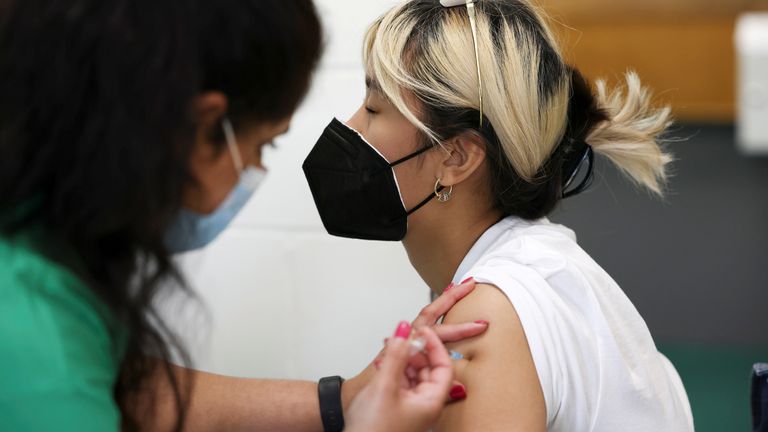 A person receives a dose of the Pfizer BioNTech vaccine at a vaccination centre for those aged over 18 years old at the Belmont Health Centre in Harrow, amid the coronavirus disease (COVID-19) outbreak in London, Britain, June 6, 2021