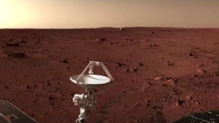 Another image of rover on the Martian surface with the lander in the background