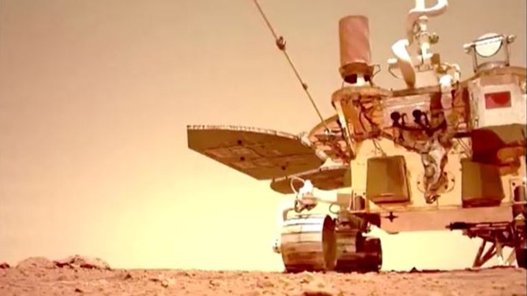 A still taken from video footage of the Zhurong rover moving along the Martian surface