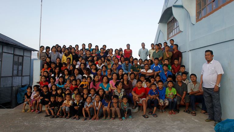 Family members of Ziona (R) pose for a group photograph outside their residence in a mountainous village Baktawng in the northeastern Indian state of Mizoram October 7, 2011. Ziona, 67, is the head of a local Christian religious sect "Chana," which allows polygamy and was founded by his father Chana on June 12, 1942, the sect believes it will soon be ruling the world with Christ and has a membership of around 400 families. He has 39 wives, 94 children, 33 grandchildren Pic oct 2011