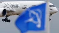 An Airbus A350 flies over a Boeing flag while landing after a flying display during the 51st Paris Air Show at Le Bourget airport near Paris, June 18, 2015