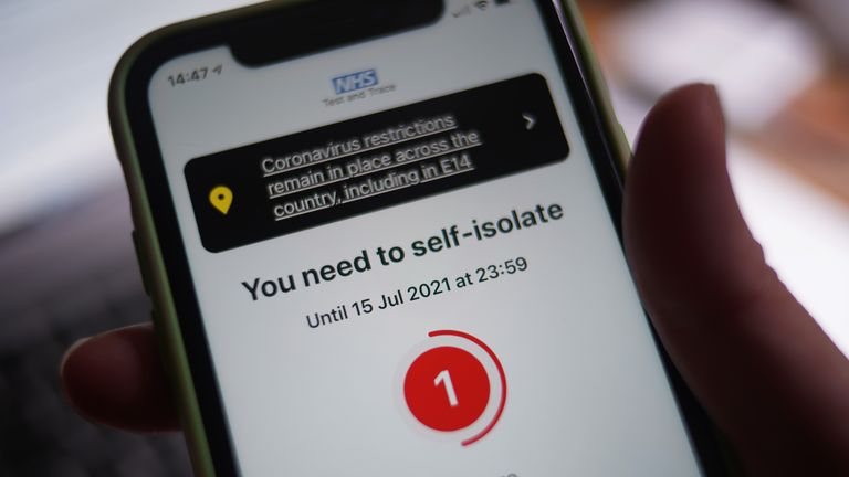 A message to self-isolate, with one day of required isolation remaining, is displayed on the NHS coronavirus contact tracing app on a mobile phone, in London. Picture date: Thursday July 15, 2021.