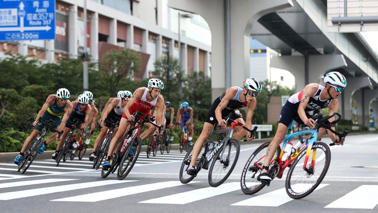 Alex Yee of Britain rides ahead of Stefan Zachaus of Luxembourg, Matthew Sharpe of Canada and other competitors as they compete in the bike leg during the men&#39;s individual triathlon at the 2020 Summer Olympics, Monday, July 26, 2021, in Tokyo, Japan. (Cameron Spencer/Pool Photo via AP)