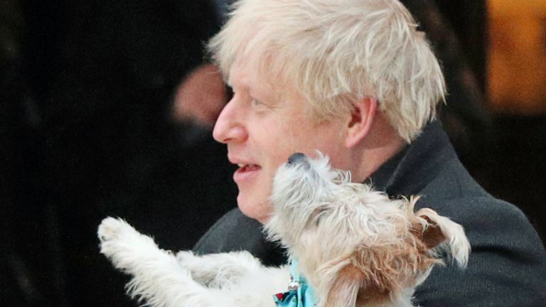 Prime Minister Boris Johnson holds his dog, Dilyn, after casting his vote in the 2019 General Election at Methodist Central Hall, London.