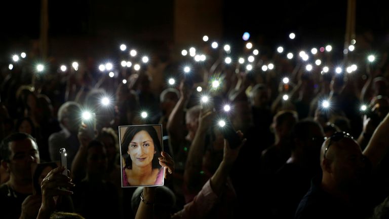 People hold up photos of assassinated anti-corruption journalist Daphne Caruana Galizia and torches on mobile phones during a vigil to mark eleven months since her murder in a car bomb, in Valletta, Malta September 16, 2018. REUTERS/Darrin Zammit Lupi TPX IMAGES OF THE DAY