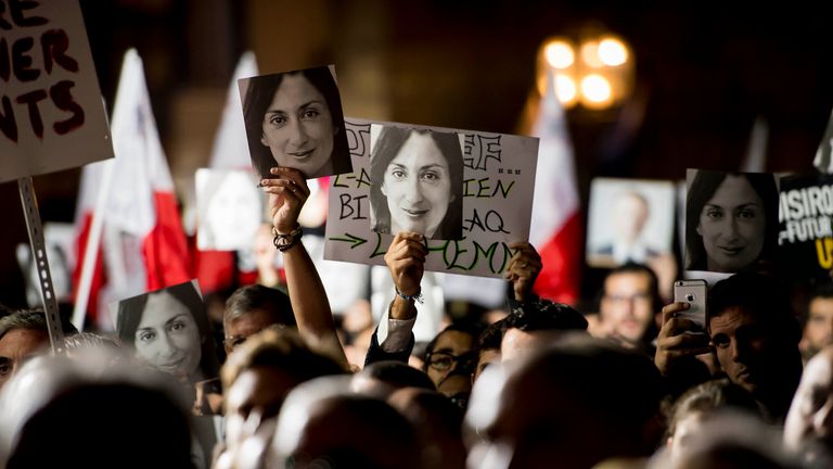 Protesters hold photos during a protest outside the office of the Prime Minster of Malta by civil groups Occupy Justice and Republica Friday, Nov. 29, 2019 in Valletta, calling for the resignation of Malta Prime Minister Joseph Muscat after his chief of staff Keith Scembri was arrested and questioned regarding the murder of slain journalist Daphne Caruana Galizia. Muscat said Friday that police found no grounds to hold Keith Schembri, his former chief of staff in custody.  (AP Photo/Rene Rossignaud)